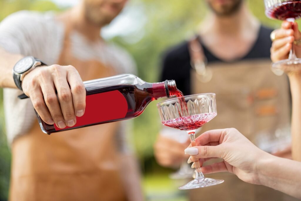 friends pouring alcohol at picnic jpg